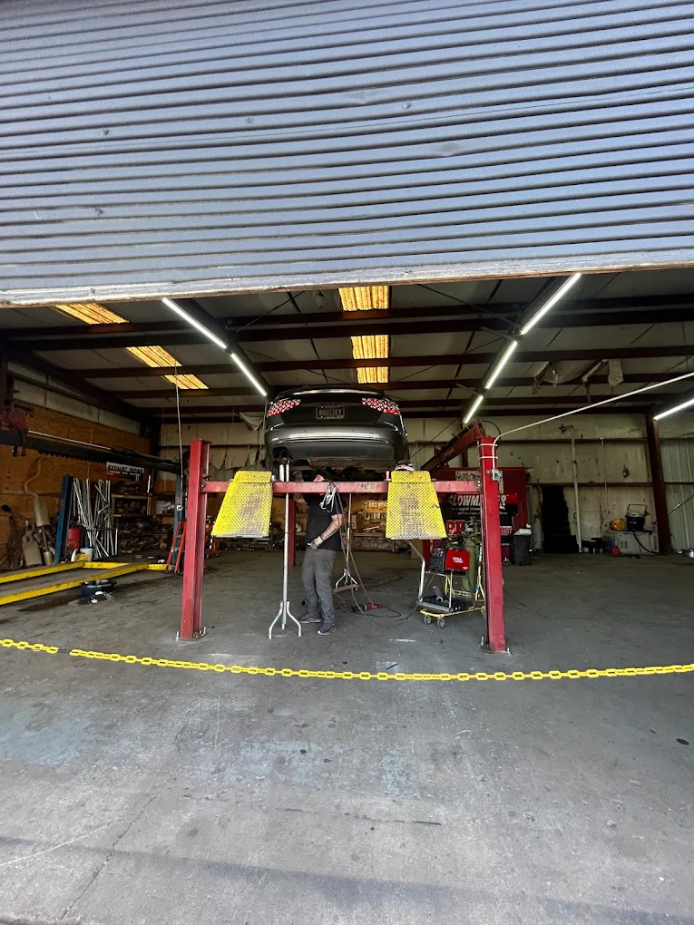 Mechanic working under a car on the lift
